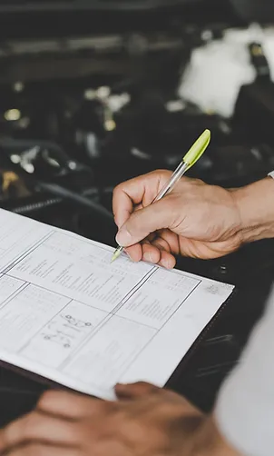young-mechanic-holding-clipboard-checklist-car.jpg